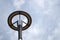 Grey round lantern on lamppost on sky background