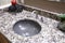 Grey round sink with granite counter.