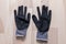 Grey rubberized work gloves on wooden surface