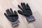 Grey rubberized work gloves on wooden surface