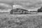 Grey scale shot of a wooden barn on a farm captured in Foxton, New Zealand