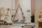 Grey scandinavian tent and pillows in cozy playroom interior with rugs and wooden furniture, real photo