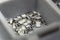 Grey scattered microscopic SMT surface mount chip resistors sorted in grey storage container