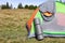 Grey sleeping bag on camping tent and mat outdoors, space for text