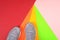 Grey sneakers on colorful background