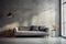 Grey sofa against window in grunge room with concrete walls. Loft home interior design of modern living room