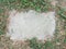 Grey stepping stone in green grass or lawn