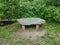 Grey stone or rock bench or seat or table