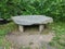 Grey stone or rock bench or seat or table