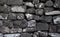 Grey stone wall background or wallpaper. Rough grey stone bricks design.