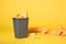 Grey Trash Bin on Vibrant Yellow Seamless Background