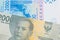 A grey two thousand Indonesian rupiah bank note paired with a blue, two thousand West African franc bank note.