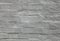 Grey wall, texture, background. The building wall, painted with whiting. Wavy and bumpy surface. Gray brick wall