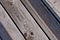 grey weathered wood planks of a boardwalk in diagonal view
