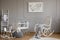 Grey whale on poster in classy baby room interior with white wooden rocking chair, rocking horse, crib and scandinavian ladder,