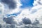 Grey and white clouds. Beautiful cumulus clouds in the blue sky. The blue sky shines through the clouds