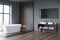 Grey and wood bathroom space with open vanity. Corner view
