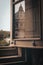 Greyscale shot of an old opened wooden window with the reflection of a dome