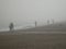 Greystones beach, fishermen in the fog morning