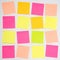 A grid of colourful blank sticky notes with copy space