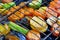 On the grid grill are fried vegetables. Potatoes, tomatoes, peppers, eggplants, cucumbers, zucchini, carrots and seasonings with o