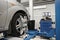 Grid sensor sets mechanic on auto. Car stand with sensors wheels for alignment camber check in workshop of Service