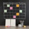 Grid timetable schedule with note paper on black chalkboard back