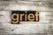 Grief Letterpress Word on Wooden Background