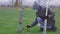 Grieving woman at cemetery near soldier`s grave