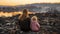 Grieving woman and child observing the heartbreaking aftermath of a city destroyed by an earthquake