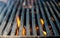 Grill bbq close up and bright hot flames, outside summer cookout, empty barbecue burning wood with smoke, blurred fire and charcoa