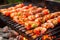 grill filled with skewered shrimp over red-hot coals