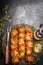 Grill time with marinated skewers, meat fork, herbs spices and oil on dark rust metal background