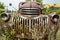 The grille and broken headlights on a 1943 Chevy truck in a junkyard in Idaho, USA - July 26,2021