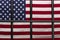 The grille of the detention cell on the background of the American flag. Concept: court session, jury trial, sentencing.