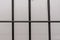 The grille of the pre-trial detention cell on a light background. Concept: court session, jury trial, sentencing.