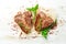 Grilled aged T-bone steak with rosemary on a white wooden background. Top view. Rustic style