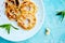 Grilled apples with cinamon on white plate on blue background