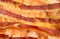 Grilled bacon slices forming a detailed texture, closeup