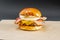 Grilled Beef Burger with Lots of Cheddar Cheese, Shredded Bacon, Grilled White Onion,