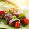 Grilled beef shishkabobs on green plate