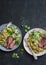 Grilled beef steak and quinoa corn mexican salad on dark background, top view. Delicious healthy balanced food