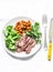 Grilled beef steak, spicy stewed chickpeas, broccoli - delicious healthy lunch on a light background, top view