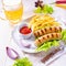 Grilled bratwurst with chips and cold beer