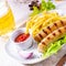 Grilled bratwurst with chips and cold beer