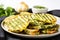 grilled bread slices served on a plate, basted with garlic herb butter