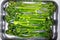 Grilled broccolini in baking dish. Baked baby broccoli. Food background. Top view. Close-up