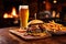 grilled burger and fries next to cold craft beer