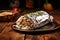 grilled burrito wrapped in silver foil on a wooden table