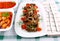 Grilled cevapcici with ajvar and giant white beans